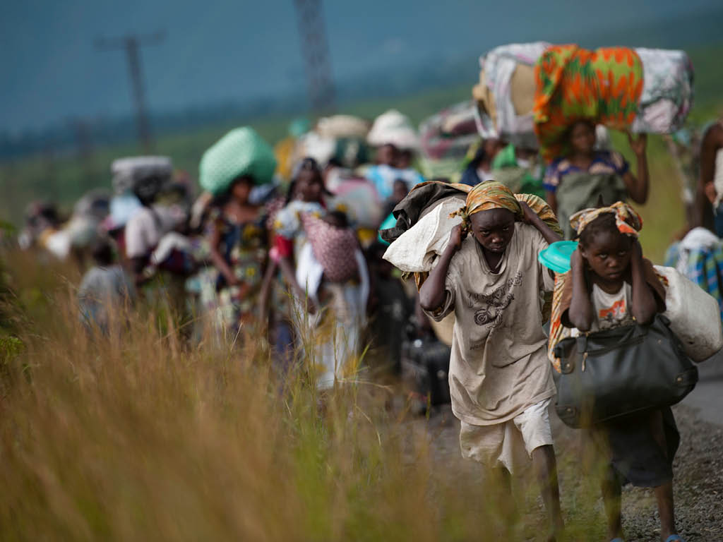 Thousands of Congolese flee the town of Sake, 26km west of Goma, following fresh fighting in the eastern Democratic Republic of the Congo town on November 22, 2012. Fighting broke out this afternoon causing people to flee the town and head east, towards Goma, to the camps for the internally displaced in the village of Mugunga.
