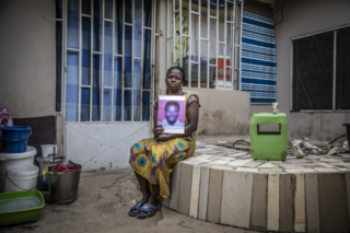 Diane Mansu, wife of Kawdwo Nsiah, one of 44 Ghanians who were killed with 12 other west Africans in The Gambia. They were attempting to reach Europe by boat from Senegal, when they went off course and landed in the Gambia on July 22nd - the anniversary of the coup that brought Jammeh to power in 1994. ©Jason Florio / TRIAL International