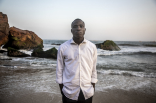 Enoch Amo Mensah, son of murdered Ghanaian migrant Enoch Amos. His father was killed along with 56 West Africa migrants in The Gambia by Jammeh's security forces in 2005. The sole survivor from the massacre, Martin Kyere said he witnessed one of Jammeh's soldiers take a machete and cut Enoch's father arm off after he asked to have the ropes around his wrist loosened. ©Jason Florio / TRIAL International