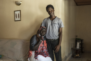 Fatou Jaiteh the second wife of Haruna Jammeh and their son Modou Lamin. Haruna disappeared in July 2005 along with his sister Marcie. According to witnesses President Jammeh ordered the murder of his cousin Haruna Jammeh after he criticised Jammeh for his abuse of power. © Jason Florio / TRIAL International